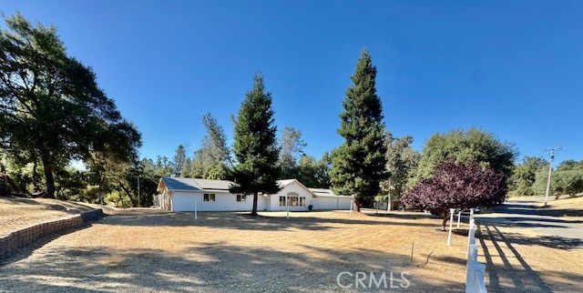 Welcome to the ever so tranquil communality of Quail Ridge Estates and discover this spacious three-bedroom, two-bath home nestled perfectly on a serene 3-acre lot. Constructed in 2007, this residence was designed with effortless mountain living in mind. The open kitchen boasts elegant granite countertops, while the high ceilings create a sense of openness. Enjoy your covered rear patio with a generous fenced area offering three access gates for your furry friends, a double driveway for extra parking along with the large garage as well as the adorable detached "Horse Barn". You will also love the Whole House Generator for peace of mind if the power goes out. Speaking of Power, this home offers a SOLAR SYSTEM with a payment of approximately $300 per month. Imagine paying this little when the current PGE costs to run a home have been skyrocketing at a record pace. It's a beautiful neighborhood and a home worth putting on your list of properties to see here.