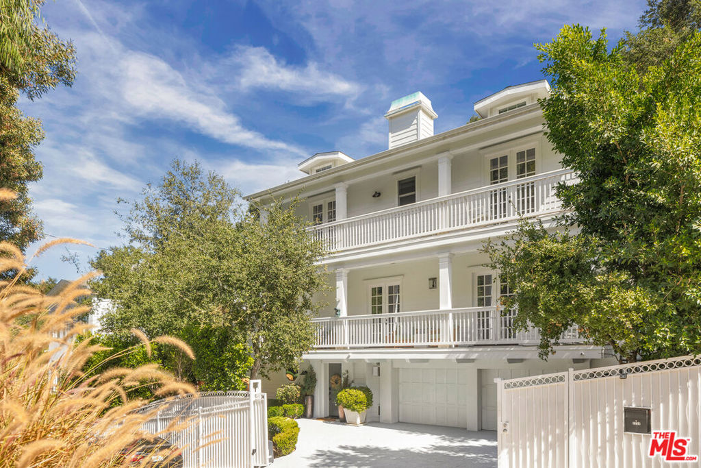 Tucked behind a private gated driveway in the heart of the Hollywood Hills and located within the coveted Wonderland School District, this stunning 3,825 sq.ft. East Coast Traditional offers timeless style and modern luxury across a generous 11,792 sq.ft. lot. With 4 spacious bedrooms, 5 bathrooms and a dedicated office, this beautifully appointed home blends comfort and functionality for today's lifestyle. An open-concept floor plan and abundant natural light create a seamless flow throughout. The chef's kitchen is a standout, featuring a large center island, custom cabinetry, and top-of-the-line Viking appliances ideal for entertaining or everyday living. Upstairs, The spacious primary retreat boasts a luxurious bathroom with a free-standing tub, dual vanities, an oversized shower, and a large walk-in closet. The secondary rooms all include large bathrooms and ample closet space. A spacious family room opens through a full wall of collapsible glass doors to a sun-drenched backyard retreat. Enjoy year-round relaxation with a solar-heated pool and spa, built-in fire pit, and manicured outdoor spaces perfect for entertaining. Smart home features include a Control4 system and indoor/outdoor security cameras. Minutes from the Sunset Strip, this home offers both privacy and proximity to the best dining, shopping, and nightlife Los Angeles has to offer.