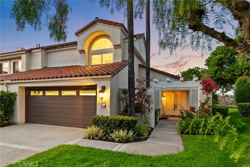 Located in the highly desirable Turtle Rock Pointe community, a haven of neighborly warmth and charm, this outstanding end unit home boasts breathtaking unobstructed panoramic views of city lights and the scenic Strawberry Farms golf course - spectacular views that can be appreciated from nearly every room throughout the residence. This beautifully reimagined home encompasses nearly 2,100 square feet of thoughtfully enhanced living space, having undergone an impressive remodel with extensive high-end improvements including brand new windows and doors throughout, elegant custom luxury vinyl wood flooring, a stunning custom staircase, personalized fireplace, and numerous additional enhancements. Perfectly situated on a tranquil cul-de-sac, this end unit features a wonderful backyard retreat with ample space for outdoor dining and entertaining, plus a lovely lawn area that's perfect for children and pets to enjoy. Enter to discover bright, airy interiors with an inviting open concept design that seamlessly connects the kitchen nook, formal dining room, elegant living room, and comfortable family room. The tastefully renovated kitchen features top-quality stainless steel appliances, while the luxurious primary suite offers a partially remodeled resort-style bathroom with a separate walk-in shower, indulgent soaking tub, double vanities, LED mirror, and an oversized walk-in closet. This three bedroom, three full bathroom residence includes a highly desirable downstairs bedroom perfect for guests or multi-generational living, and the upstairs secondary bathroom has also been partially remodeled. The roomy two-car garage offers excellent storage and convenience. Turtle Rock Pointe represents an exclusive enclave of just 188 homes, creating an intimate community atmosphere where residents enjoy friendly interactions and peaceful walks along tree-shaded streets. Community perks include access to two distinct pools and spas. The location provides excellent access to top-rated schools including Concordia, UCI, Uni High, Vista Verde, and Bonita Canyon Elementary, while being just minutes from Orange County's renowned beaches, diverse shopping and dining options, and convenient freeway connections.