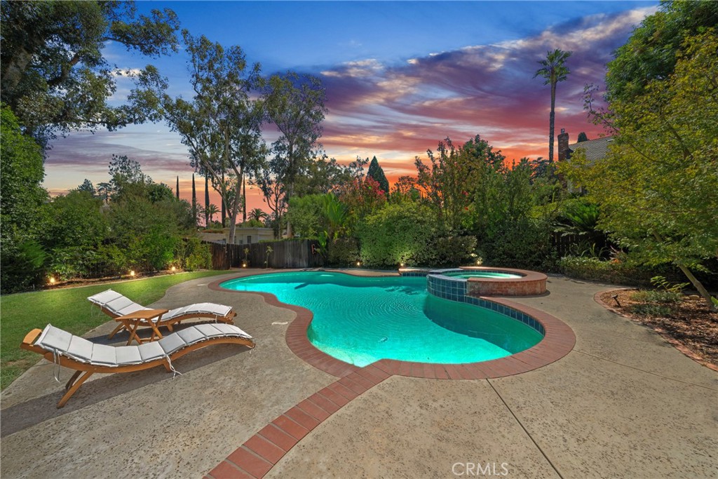 ***POOL HOME, PAID OFF SOLAR*** Charming Redlands Home with Pool, Spa, RV Parking & Solar – Steps from the Country Club! Welcome to this delightful custom-built home located in the desirable Mariposa School District, just steps from the Redlands Country Club. Packed with character and thoughtful upgrades, this property offers a perfect blend of indoor comfort and outdoor living. The beautifully landscaped backyard is a true retreat, featuring a spacious lawn, pool and spa, and RV parking accessible via a back entrance. Three charming brick patios open from the home through French doors, creating seamless indoor-outdoor living spaces ideal for entertaining or relaxing. Inside, the large entryway leads to a bright living room with stunning windows and a cozy window seat. The formal dining room, highlighted by a charming brick wall, opens to two patios. The remodeled kitchen boasts double stainless steel ovens, granite countertops, updated flooring, fresh paint, and modern fixtures, and flows effortlessly into the family room with dinette and fireplace. The primary suite is a private escape with expansive windows, French doors to the backyard, and a remodeled en-suite bath. All bathrooms have been updated, and the home features new flooring throughout, including wood and tile, as well as a large indoor laundry room, tankless water heater, and new furnace. Best of all, owned solar panels keep your electric bills low while you enjoy year-round comfort. This Redlands gem combines timeless charm with modern efficiency—schedule your private showing today!