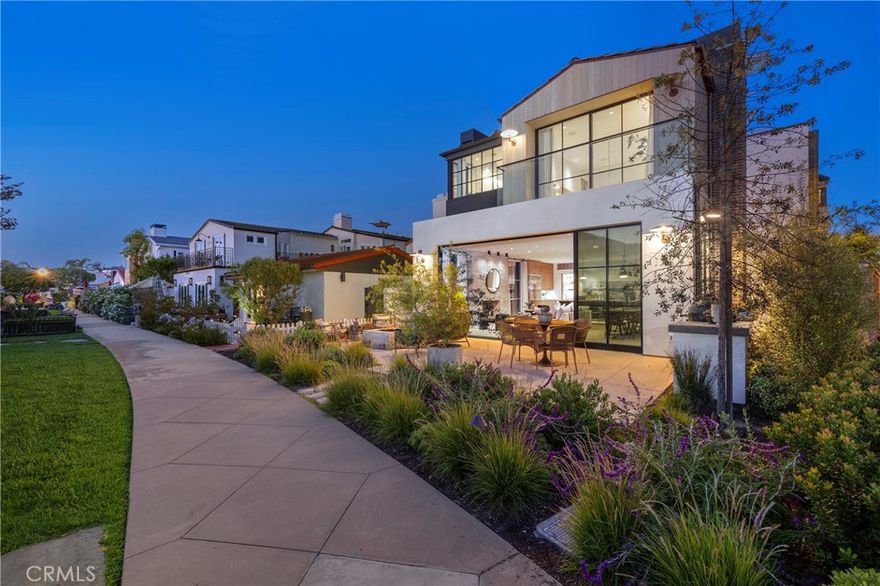 Experience elevated island living at 207 Via Eboli—a newly constructed architectural gem by Brandon Architects, situated on an expansive lot in the heart of Lido Isle. This stunning home offers a refined blend of organic-modern and mid-century design influences, paired with masterful craftsmanship and premium finishes throughout. Boasting 4 bedrooms (one used as an office) and 4.5 baths, the residence welcomes you with a custom solid pivot door into a dramatic great room with soaring ceilings and a tumbled limestone fireplace. Floor-to-ceiling glass walls frame the lushly landscaped strada, opening via custom sliders to a spacious patio outfitted with a limestone fire pit, built-in seating, and a fully equipped outdoor kitchen—creating the perfect setting for indoor-outdoor living and entertaining. The open-concept chef’s kitchen is a showpiece, featuring a large statement island, premium appliances from AGA, Sub-Zero, and Wolf, and an oversized butler’s pantry. Materials were chosen with care and intention, including wide plank oak flooring, white oak custom cabinetry, curated lighting, and tile from Concept Studio. Portola Paint’s Roman Clay and lime wash finishes complement Italian slabs of Arebescato, Calacatta, and Statuario marble. Ascend the wide glass staircase to find four beautifully designed bedroom suites. The primary retreat is a luxurious sanctuary, complete with a glass balcony, limestone fireplace, resort-style bath, and an expansive walk-in closet. Secondary bedrooms are equally sophisticated, perfect for family or guests. Additional amenities include a rooftop deck with panoramic views of Newport Beach, a custom wine room with dual-zone cooling, a private elevator, and tailor-made window treatments. The exterior boasts solid hemlock wood siding, matte charcoal brick, a V-groove garage door, and copper Louis Poulsen lighting. With 51 feet of frontage, the home offers an oversized two-car garage and full-size port. A true statement of elegance, innovation, and casual coastal sophistication—this home captures the essence of Lido Isle luxury living.