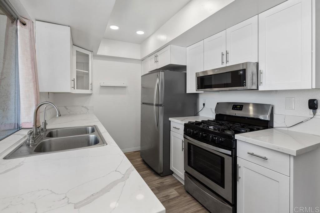 This beautifully renovated ground-level condo offers a spacious private patio with stunning views of Cowles Mountain perfect for relaxing or creating your own garden retreat. The gourmet kitchen features granite countertops, while the home boasts luxury vinyl plank flooring throughout, fresh interior paint, and central air conditioning for year-round comfort. Enjoy extra storage off the patio and ample guest parking. The generously sized bedroom includes a removable partition wall, ideal for creating a dedicated home office. Situated in the highly sought-after San Carlos community, you’ll be close to shopping, dining, hiking trails, Lake Murray, and Mission Trails Golf Course. Community amenities include a sparkling pool and spa, fitness center, and clubhouse with a pool table offering the perfect balance of comfort, convenience, and recreation.