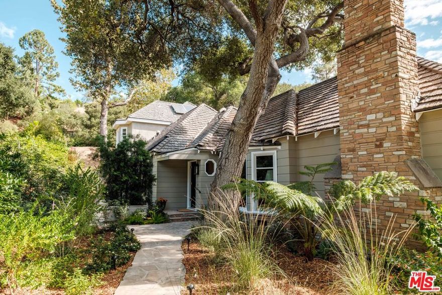 Creative Canyon Compound. Built by the original family who helped shape one of Glenoaks Canyon's most coveted enclaves, this 1940s historic home blends nature, history, and possibility. Set on a rare double lot, 2528 Sleepy Hollow offers an exceptional combination of expanse and serenity. The main house is rich in character, featuring hardwood floors, bay windows and original tile. Its thoughtful layout suits both festive gatherings and quiet moments. Three bedrooms and two baths anchor the main floor while a 400+ square-foot kitchen with generous countertops, abundant storage, and room to seat a crowd will inspire your inner epicurean. Sunlight filters into the formal living room from the north, illuminating a space that feels both refined and inviting, while a step-down den features built-in bookcases, a cozy window seat, and custom drawers perfect for stashing your record collection. A permitted second-story addition creates an airy, vaulted primary suite with exposed oak beams, multiple closets, and a converted attic for work or play. Outdoors, a covered patio with a brick BBQ and wet bar overlooks a breathtaking pool lined with azure tile, while a two-story guest house with bath offers endless flexibility for additional living and creating. Owned solar and a flat upper parcel large enough to build a second residence or ADU are only a few of the extra surprises. Minutes from Eagle Rock, Highland Park, Pasadena, La Canada, and Downtown Glendale, this unicorn of a home channels more of NELA's easygoing vibe versus suburbia and offers a rare blend of artistry, privacy, and tranquility.