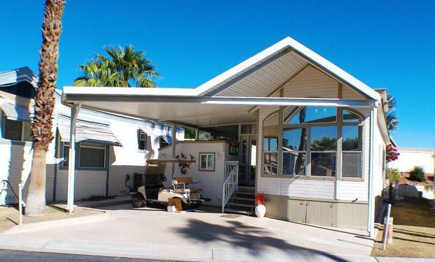 This wonderful Cavco Park Model located on the East Wall has Auto Shutters on the Deck Area.