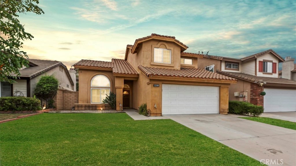 Tastefully upgraded home in the desirable Wild Rose community! This charming property features gorgeous laminated wood flooring in the main living areas and custom two-tone tile in the kitchen, laundry room, and downstairs vanity. The formal living room boasts soaring vaulted ceilings that create a bright and open feel. The remodeled kitchen offers stunning countertops and modern finishes, and flows seamlessly into the cozy family room with a toasty fireplace—perfect for relaxing or entertaining. The spacious primary suite includes high ceilings, a private patio deck with serene mountain views, and a luxurious bath with a separate soaking tub and shower, dark marble tile flooring, and a custom-designed walk-in closet. Additional highlights include upgraded carpet in the bedrooms, dark marble tile in the upstairs hall bath, custom window coverings, a private in-ground spa, and a two-car attached garage with built-in storage cabinets and finished flooring. Located within walking distance to the neighborhood park and just minutes from the Promenade Shops at Dos Lagos and The Crossings, this home offers the perfect blend of comfort, style, and convenience. Don’t miss one of the best values in Wild Rose!