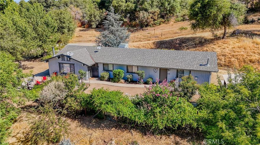 Welcome to 33301 Road 233 in North Fork! This beautifully remodeled hidden gem nestled in the trees on just over 2 acres backs up to tranquil Sierra National Forest. This versatile property offers the perfect blend of peaceful seclusion and multi-generational comfort, with 4 spacious bedrooms, 2 full bathrooms, and a bonus room ideal as an office, den, or even a 5th bedroom.



Step inside to find two inviting living areas, each with its own entrance! Perfect for extended family, rental income, or guest privacy. The open living space is highlighted with oversized windows inviting natural light that frames scenic views and frequent visits from local wildlife. Cozy up by the wood-burning fireplace during the winter months, and gather around the generous dining area to create lifelong memories.



Whether you're seeking a primary residence, vacation getaway, or income-producing property, this home checks every box. All just a short drive to the sparkling waters and year-round activities of Bass Lake. Don't miss this rare opportunity to own your own slice of the Sierra foot hills, serenity, space, and endless potential await!