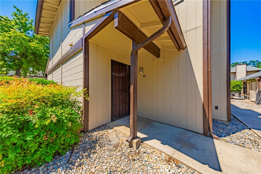 Discover this beautifully remodeled two-story condominium in a gated community offering a sparkling pool and lush green space. Ideally located near scenic Bass Lake, Yosemite National Park, and just minutes from downtown Oakhurst, this home combines convenience with mountain living. Updated in 2023, it features fresh tile, plush carpet, modern paint, upgraded lighting, a new microwave range hood, range, and dishwasher. The inviting living area boasts elegant custom crown molding and a unique lighting feature, creating a warm ambiance for relaxing or entertaining. Enjoy the convenience of a separate laundry room and a spacious pantry tucked neatly away from the main living space, providing extra storage and functionality. This unit includes two premium parking spaces, one of which is covered for added protection and ease. Whether you're seeking a full-time residence, vacation getaway, or investment opportunity, this move-in ready condo offers comfort, style, and access to the best of the Sierra foothills.