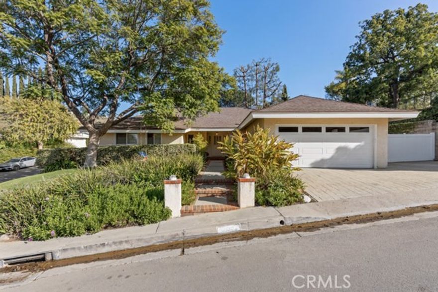 Welcome to this beautifully updated home, ideally located south of the Boulevard in the serene hills of Studio City. Enter into a grand formal living and dining room boasting vaulted, wood-beamed ceilings. At the heart of the home, the gourmet eat-in kitchen, outfitted with top-of-the-line appliances, opens seamlessly to the spacious family room. Three sets of French doors lead out to a tranquil backyard oasis with a sparkling pool/spa, expansive patio and large side yard. Additional highlights include a large enclosed driveway with ample parking, RV space with hookups, a spacious enclosed loft and dedicated laundry room.