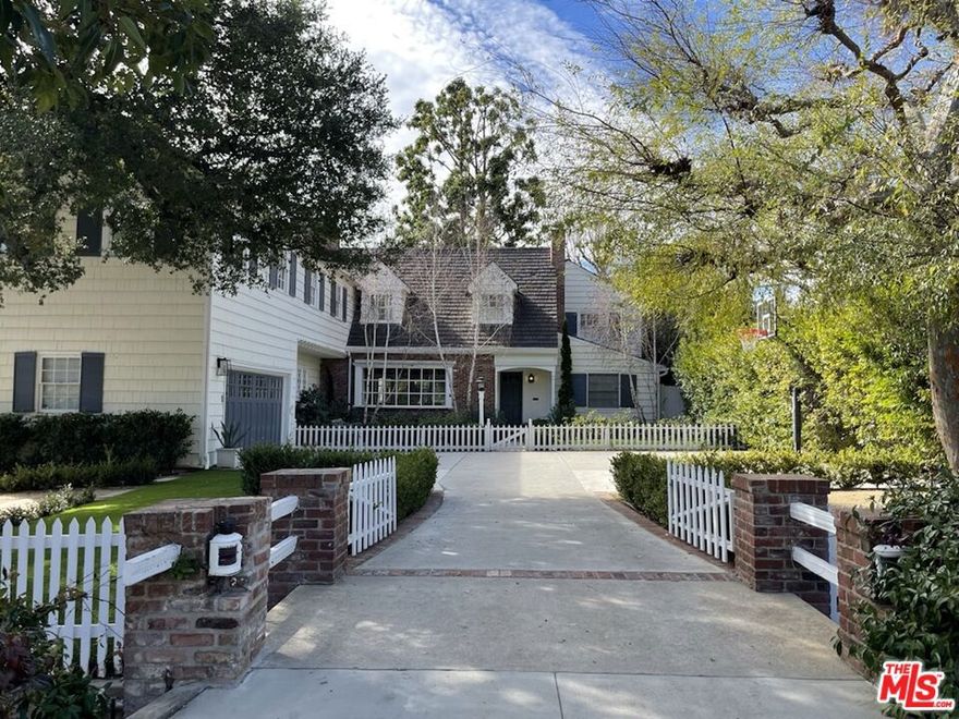 Indulge in the luxury, space, and style of this incredible traditional home in a desirable Brentwood location north of Sunset! Designed by noted architect Gerard Colcord in 1949 this immaculate haven reveals an impressive blend of original details and innovative features that lend a timeless appeal. Discover 5 bedrooms, 6 baths, bonus room and a two-car garage all on approximately 5563 sq ft with generously sized gathering areas with gleaming wood floors, elegant molding, and recessed lighting. Brilliant sunlight spills through multiple glass doors and picture windows to create a welcoming ambiance throughout. Upstairs features a generous vaulted recreational room used as a gym which could become an additional 6th bedroom or home theatre.  An expansive island accommodates guests in the updated designer kitchen equipped with top-of-the-line appliances, marble countertops, and gorgeous cabinetry. A service wing houses a laundry room and an entire second service kitchen to provide additional prep space. Stylish lighting shimmers over the newly added family room with Fleetwood doors that slide out of view, erasing the line between indoor and outdoor living.  The primary suite features exposed beams, vaulted ceilings, and an elegant chandelier and is adjoined by a large separate sitting area highlighted by textured wallpaper which brings color and depth to the room. French doors off the sitting area open to a balcony overlooking the oasis-inspired backyard which features mature foliage and an expansive verdant yard offering you an inviting escape and plenty of space to entertain whether you're dining al fresco or soaking up the sun on leisurely weekends. Take a refreshing dip in the sparkling pool or enjoy a nightcap under the stars in the outdoor spa. All of this stately and enviably setback from street with a motor court providing an abundance of parking. Come experience the lifestyle most only dream of before the opportunity passes you by! Kenter, Paul Revere, and Palisades High School districts, (Buyer to Verify). All offers due by Wednesday, March 16 at 12 PM.