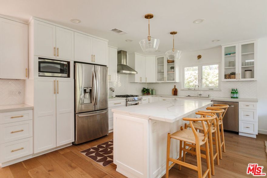 Welcome home to this Culver City gem! Extensively renovated in 2018, the 3 bedroom 2 bathroom home with an additional 300 sq ft of living space from the finished garage has every detail covered. The kitchen features quartz countertops, LG appliances, and soft-close wood cabinetry with storage, an island bar, and large pantry closet. The primary suite features a freshly styled bathroom and a walk-in closet. There are two additional bright bedrooms with a stacked washer/dryer and a custom-designed second full bathroom between them. A bright and airy home that includes a dining area and two living spaces, you'll delight in two outdoor living areas! French doors off the family room lead to a manicured backyard complete with turf and smart irrigation. The former garage was transformed into an air conditioned bonus space for a gym, office, or guests with white oak floors, recessed lighting, and a massive storage closet. A side yard storage area remains for bikes and garden supplies. Close to Farragut Elementary and other award-winning Culver City schools.