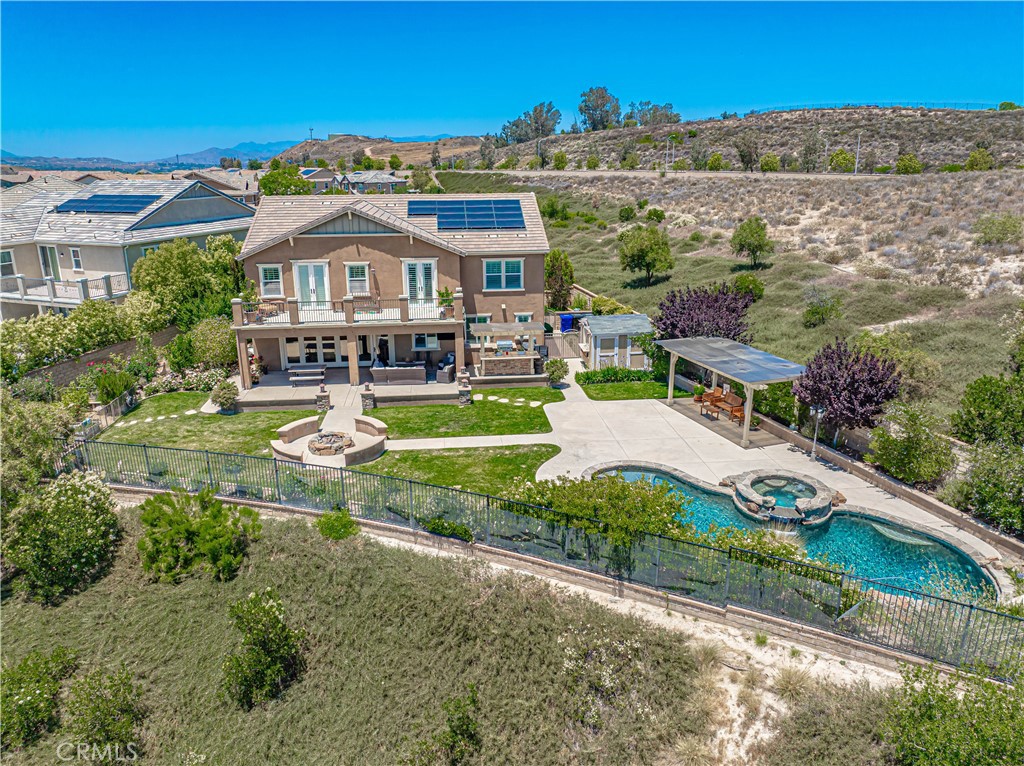 STUNNING VIEW HOME in Gated River Village!
Situated on a premium cul-de-sac lot with no neighbors to the left, this model-perfect 5-bedroom + loft, 4.5-bath pool home offers one of the largest and most private yards in the community. Step inside to a light-filled open floorplan featuring gorgeous hickory wood flooring, crown molding, and a spacious great room with a stacked stone fireplace and bi-fold accordion patio doors that seamlessly connect indoor and outdoor living. The backyard is a true entertainer’s paradise, with panoramic views, a custom sparkling pool and spa, built-in BBQ island with pergola, fire pit, covered patio, bar station, and lush, park-like landscaping with LED lighting and redwood-raised garden beds. The chef’s kitchen is a showstopper, featuring: Oversized custom Labradorite granite island with seating and copper farmhouse sink, top-of-the-line stainless appliances including a 6-burner range, 42” built-in fridge, and Fischer & Paykel drawer dishwasher, custom walk-in pantry with stainless steel countertop, upgraded cabinetry with oil-rubbed bronze hardware, stone and glass mosaic backsplash, limestone counters, and under-cabinet LED lighting, downstairs includes a private next-gen suite/studio with its own entrance, full bath, custom brick wall accent, barn door, and built-in cabinetry — perfect for in-laws, guests, or a home office (plumbed for a sink). Upstairs, the luxurious primary suite features a private balcony with breathtaking views, dual walk-in closets, soaking tub, oversized shower, and double vanities behind a stylish barn door. Additional highlights include: OWNED solar system, 100-foot paver driveway, walkways & porch, custom wine closet with Sub-Zero wine fridge and refrigerator drawers, upstairs laundry with built-in cabinetry, utility room with stainless counters and automatic dog water station, berber carpet, upgraded lighting throughout, and more!
HOA amenities include a pool, spa, clubhouse, and walking trails. This home offers luxury, privacy, and exceptional design—truly one-of-a-kind!
