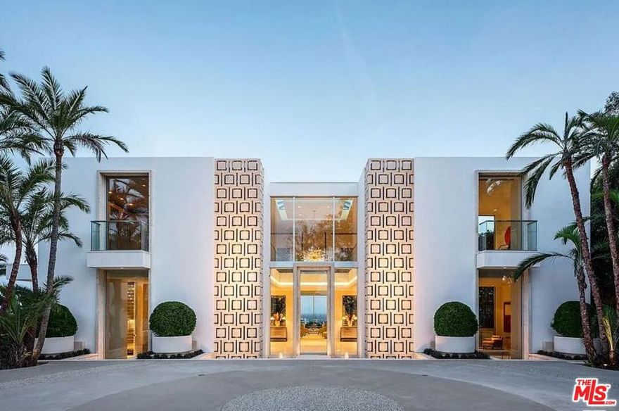 "The Promontory" The ultimate view estate in LA. Situated on 8/10ths of an acre with unobstructed head-on views spanning from downtown LA to the ocean. A masterful creation by renowned architectural designer, Tim Morrison. A world-class modern estate implementing classic Hollywood Regency details and a grand scale featuring every conceivable amenity. Meticulously crafted interior of approximately 11,000 sf showcasing unparalleled views, scale, and quality. Enter a spectacular 2-story foyer, grand dining room, formal living room, and a bar all flow effortlessly for entertaining. Spectacular primary suite with explosive jetliner views, large sitting room and stunning dual baths and closets. Additional features include a state-of-the-art movie theater/screening room, 4 bedrooms, gym, and gourmet kitchen. One of the few view estates that possess a gated entry and vast motor court with 4-car garage. The rear grounds offer spectacular formal gardens, rolling lawns, and a dramatic floating zero edge pool. Located on the end of an exclusive cul-de-sac just minutes from the best restaurants and shopping in the city. Shown to pre-qualified clients only.