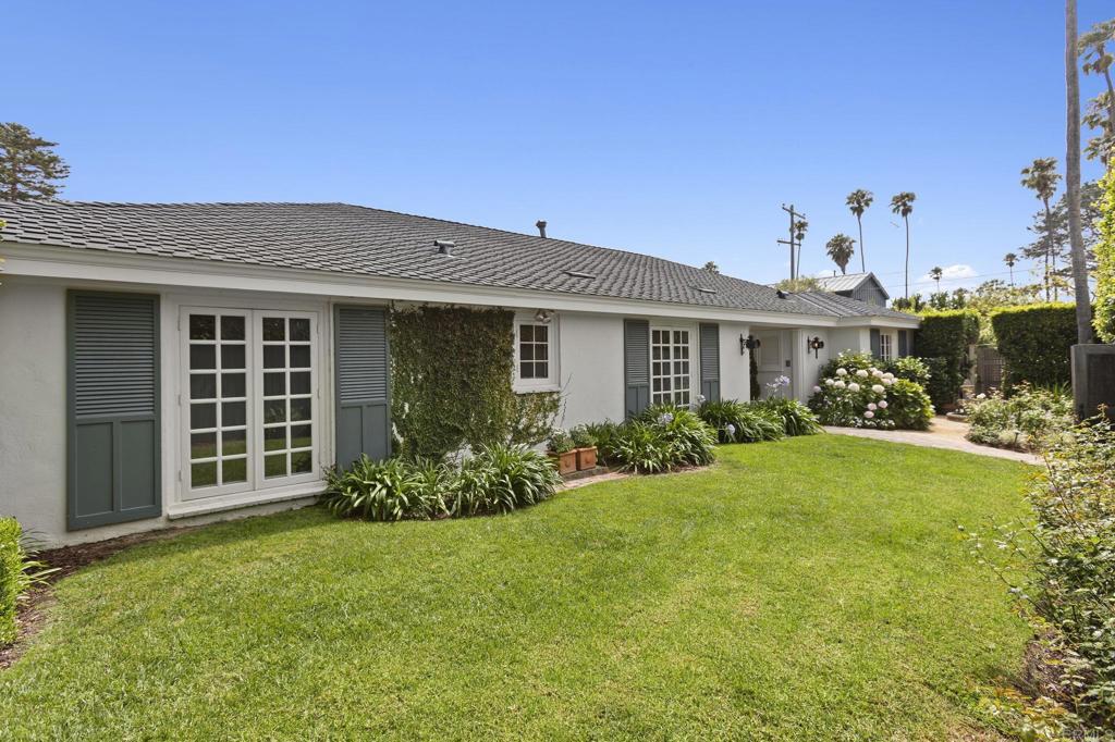 315 Mira Monte is the kind of La Jolla home that immediately draws you in, combining timeless character, light-filled spaces, thoughtful upgrades, seamless indoor-outdoor living, and an unbeatable location in the coveted Lower Hermosa neighborhood—just blocks from Windansea Beach and Bird Rock’s shops and cafés. This single-level coastal gem sits on a sprawling, flat, corner lot and offers both privacy and lifestyle, with lush landscaping, multiple patios, a hot tub, sport court, outdoor shower, and plenty of space for a future pool. Inside, sun-drenched living spaces showcase Brazilian hardwood floors, detailed millwork, and original built-ins that give the home a sense of authenticity and charm. The white Carrara marble kitchen—where Wolfgang Puck and Julia Child were rumored to have once cooked—anchors the home and flows effortlessly to the formal dining room and inviting great room with a wood-burning fireplace and French doors opening to the gardens beyond. The home features 4 spacious bedrooms and 3.5 baths, including a serene primary suite tucked away at the rear of the home. Additionally, the home's large laundry room with an adjacent full bath could easily be converted back into a 5th bedroom, further maximizing the home's thoughtful layout. Modern upgrades such as owned solar, a built-in Sonos system, and central HVAC bring everyday convenience, while the thoughtful design makes living, working, and hosting a breeze. Presenting an incredible value, 315 Mira Monte offers lasting appeal as a primary residence, second home, or long-term investment in one of California’s most sought-after coastal markets. This is the kind of home that holds value—in style, in location, and in potential.