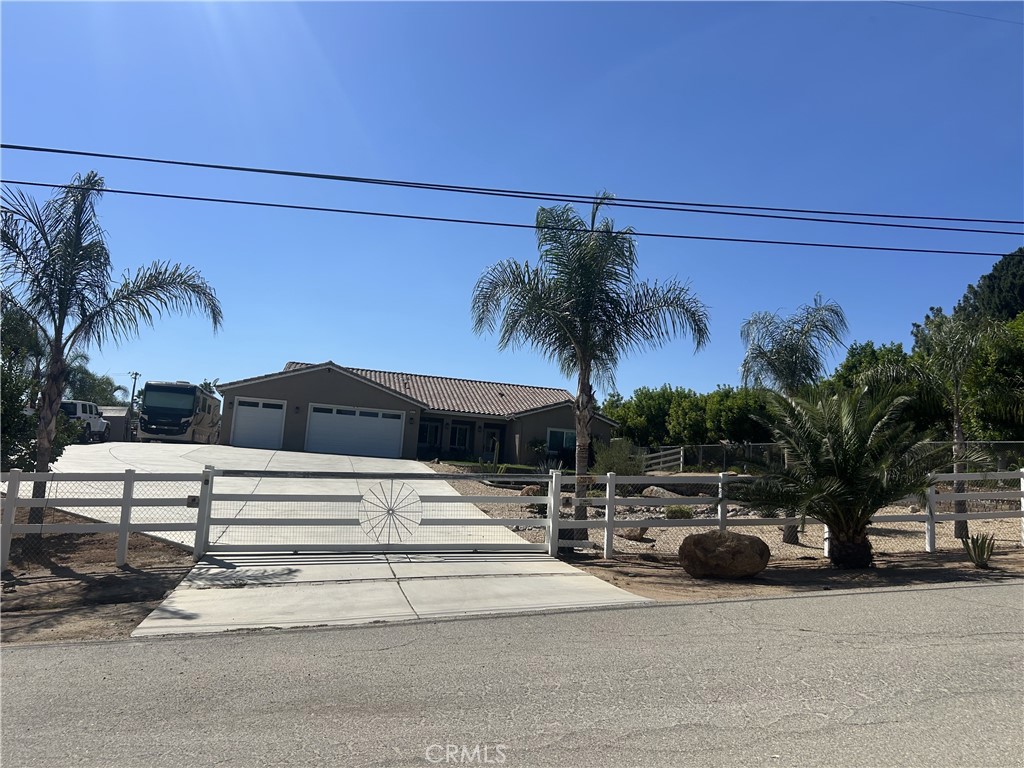 Welcome to your dream home! This custom-built home sits on 2.5 acres with ample space that has the potential to be subdivided into 2 lots or build a casita, ADU (Accessory Dwelling Unit), or a custom garage for all of your off-road toys. The property has mountain views and is in one of the most desirable areas of Woodcrest. The property is zoned for horse and Agricultural use. This beautifully spacious 4-bedroom, 2.5-bath home offers 2,827sq. ft. of living space. It offers an open floor plan with an open kitchen, a large island to entertain your guests and overlooks the family room and backyard. The kitchen has lots of cabinet space with a butler’s pantry. Kitchen has granite countertops, marble backsplash and tile flooring throughout the house. Step into your luxurious primary suite featuring a jetted tub, walk in shower, dual vanities and a spacious walk-in closet. As you enter out to the backyard you are welcomed by a 20’ x 40’ fully automated saltwater play pool, with a Baja reef entry, large spa and waterfalls. The backyard offers an abundance of additions of any kind to create your own oasis. The home is equipped with dual-zone HVAC, and dual-glazed windows. The neighborhood offers a quiet feel but is still close to schools such as Martin Luther King High School, shops and other local amenities. This home offers the best of both worlds peaceful living with city convenience. You won’t want to miss this opportunity!!