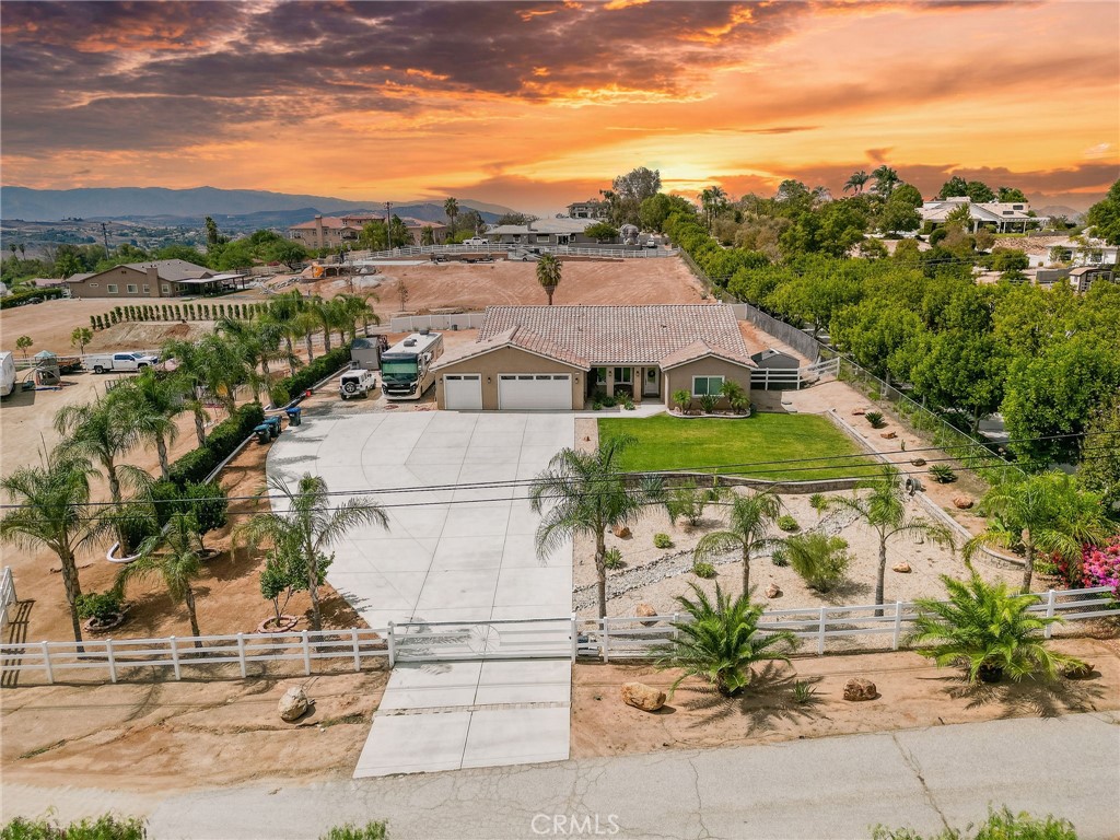 Welcome to your dream home! This custom-built home sits on 2.5 acres with ample space that has the potential to be subdivided into 2 lots or build a casita, ADU (Accessory Dwelling Unit), or a custom garage for all of your off-road toys. The property has mountain views and is in one of the most desirable areas of Woodcrest. The property is zoned for horse and Agricultural use. This beautifully spacious 4-bedroom, 2.5-bath home offers 2,827sq. ft. of living space. It offers an open floor plan with an open kitchen, a large island to entertain your guests and overlooks the family room and backyard. The kitchen has lots of cabinet space with a butler’s pantry. Kitchen has granite countertops, marble backsplash and tile flooring throughout the house. Step into your luxurious primary suite featuring a jetted tub, walk in shower, dual vanities and a spacious walk-in closet. As you enter out to the backyard you are welcomed by a 20’ x 40’ fully automated saltwater play pool, with a Baja reef entry, large spa and waterfalls. The backyard offers an abundance of additions of any kind to create your own oasis. The home is equipped with dual-zone HVAC, and dual-glazed windows. The neighborhood offers a quiet feel but is still close to schools such as Martin Luther King High School, shops and other local amenities. This home offers the best of both worlds peaceful living with city convenience. You won’t want to miss this opportunity!!