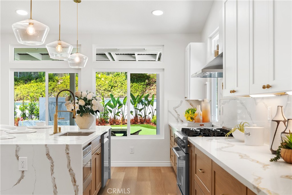 Newly Renovated Single-Story Corner Home in the Coveted Yorba Linda High School Zone! Meticulously redesigned from top to bottom, this rare corner residence offers 4 bedrooms plus a private office, combining timeless elegance with modern comfort.
Step inside to soaring, high-ceiling living and formal dining rooms—perfect for gatherings and entertaining. The designer-upgraded kitchen showcases sleek quartz countertops, premium THOR appliances including a wine fridge, a pot filler, abundant cabinetry, and a spacious walk-in pantry. An additional high-ceiling family room with a cozy fireplace opens to the beautifully landscaped backyard, creating a seamless indoor-outdoor lifestyle.
The expansive primary suite features a grand double-door entry, direct backyard access, and a spa-inspired bath with a jetted tub and dual sinks.
Outside, the resort-style backyard is newly landscaped and fully private, complete with a built-in BBQ island, water feature, putting green, fire pit, and a detached patio pavilion—perfect for entertaining or unwinding in style. Generously sized side yard with ample space for RV parking.
Notable upgrades include new windows and sliding doors, new plumbing and fixtures, new A/C system, durable luxury vinyl flooring throughout, and a 3-car garage with new garage doors, epoxy flooring, and garage openers.
Come check it out while it lasts!