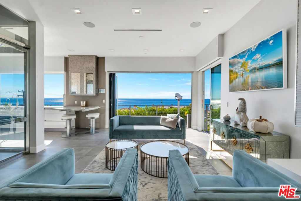 Available for sale or lease long term $30k/month, or summer $40k/month. Newly constructed Coastal beach home completed in 2020 with luxury upgrades & designer finishes. Stunning panoramic ocean and whitewater views overlooking Santa Monica Bay ( The Queens Necklace) Palos Verdes Peninsula & Catalina Island to the East and Point Dume to the West. This Malibu Road home gem, AKA (Bayshore Dr) sits on a private enclave consisting of only 13 homes with easy access to the beach. This developer's own weekend residence is available for sale or lease starting now. Features include a Chef's Kitchen w/Miele Appliances, 48" range w/ stainless steel hood, built-in combination steam oven, warming drawer, coffee maker, high gloss cabinets, pocket windows w/ serving bar & stools open from the kitchen looking out to this artistic view of Point Dume. Commercial grade glass Elevator, state-of-the-art movie theatre w/135' screen, Reclining Leather chairs, outdoor infinity glass pool/spa w/ fire-pit looking through the cascading waterfall. Built-in EVO for the professionals who love to cooke and grille. Crestron system set up for the techies, 2 car garage is finished for car collectors plus plenty of additional outside parking, built-in cabinets and storage area, refrigerator, security cameras. Newly installed wine and tasting room. jaw dropping sunrise and sunset views that you will want to experience every day. Close to the Country Mart, hiking trails tennis, surfing , famous Soho house, Nobu and all Malibu has to offer. Also includes solar panels.