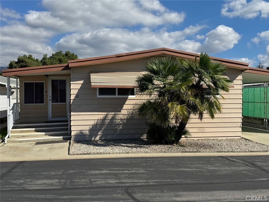 Here it is. Neat, Clean and ready to move in ready Doublewide in very nice senior park in the heart of Yucaipa. This home featurestwo good sized rooms and an extra room off the living room which can be used for an office, a hobby room or whatever you need. The open galley style kitchen features a breakfast bar at the dining area as well as a buily in china cabinet.This home has been very well maintained and the well managed park is very clean with a very reasonable park space rent. Other features include Inside laundry, good storage inside as well as two additional storage sheds. Hurry and don’t miss this great home.
