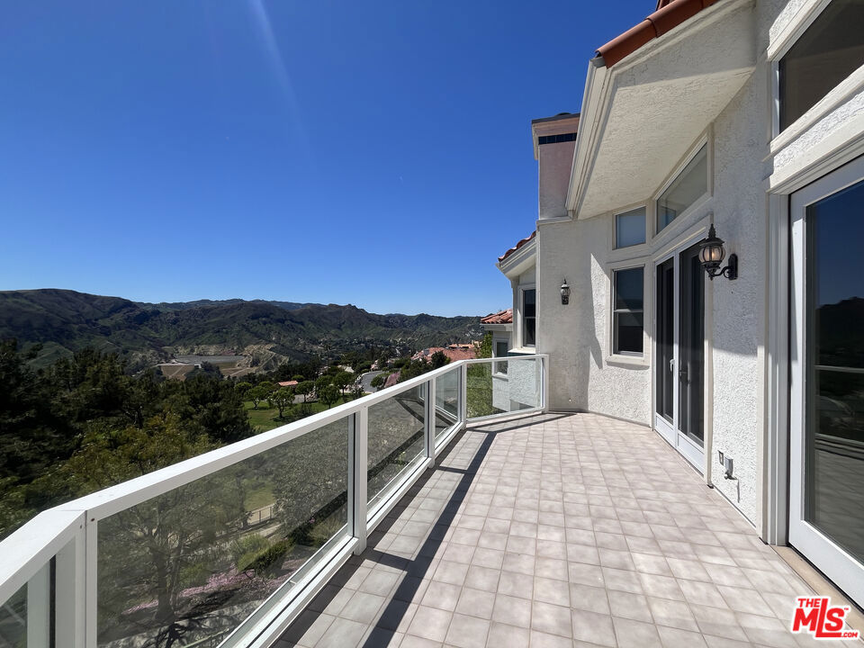 Set in the peaceful Pacific Palisades Highlands, this rare single-level residence in the Vista Catalina complex offers 2,567 square feet of thoughtfully designed living space with no stairs, an uncommon and highly sought-after feature in the area. Located within a low-density, meticulously maintained community, the home blends comfort, functionality, and privacy in one of the Palisades' most desirable settings. The three-bedroom, three-and-a-half-bath layout is ideal for a variety of living arrangements. Each bedroom is ensuite and features either oversized walk-in closets or double wall closets, creating a flexible and private environment for family, guests, or a dedicated home office.Flooded with natural light, the open floor plan is anchored by high ceilings, clean architectural details, and recessed lighting that provide a sense of volume and ease. The formal living room, complete with a fireplace, flows seamlessly into a spacious dining area and opens onto a large terrace with expansive mountain views extending the living space and offering a peaceful setting for relaxing or entertaining.The kitchen is both well-equipped and functional, featuring abundant cabinetry, granite countertops, stainless steel appliances, and a breakfast nook that looks out over the hills. An additional den or family room sits just off the kitchen, offering flexibility as a media room, casual living space, or office.The primary suite is notably generous, with its own sitting area, fireplace, and a spa-style bathroom that includes a soaking tub, separate shower, dual vanities, and exceptional closet space. One of the secondary suites is outfitted with custom built-ins, making it especially well-suited as an executive-level home office, complete with a large walk-in and two additional closets for extensive storage.Additional amenities include direct access to a private two-car garage, a separate laundry room, central air and heat, and generous storage throughout the home. Just steps from the unit, residents enjoy access to a private pool and spa and located just minutes from Palisades Village, scenic hiking trails, beaches, and top-rated schools, this property represents a rare opportunity to own a spacious, stair-free home with mountain views and exceptional amenities in one of the Palisades' most established communities. Private showings available by appointment.