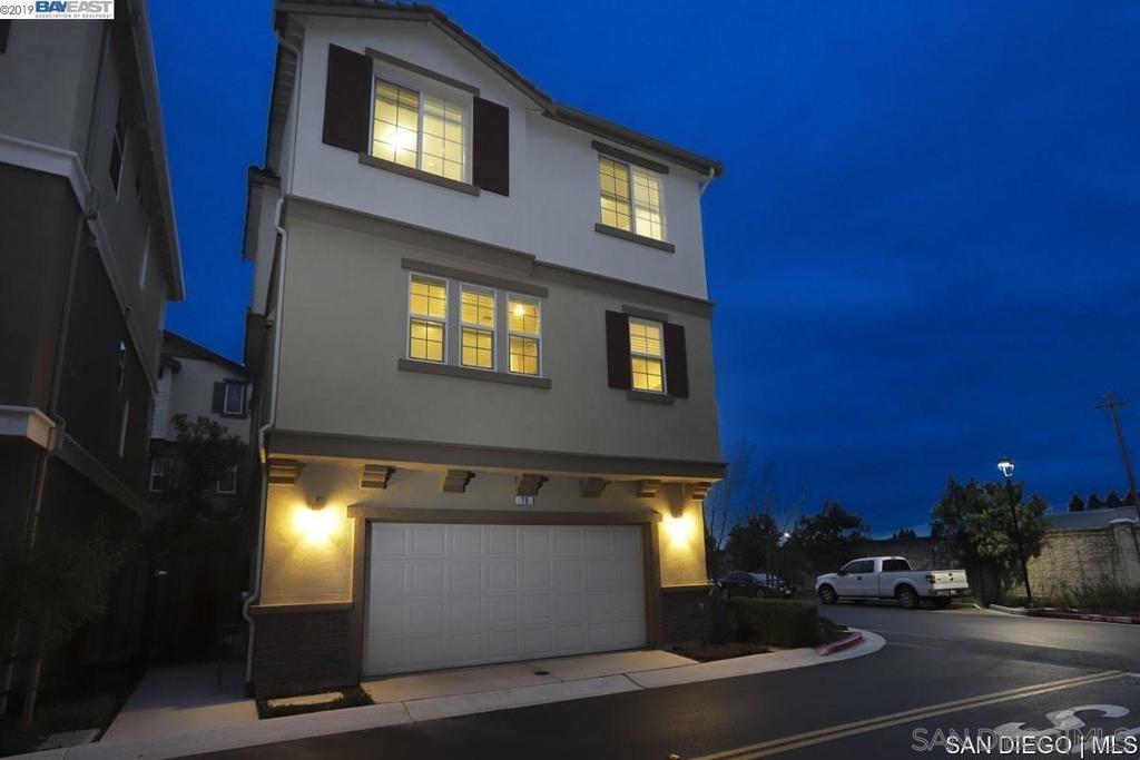 Built in 2015, this nearly-new home features the largest and most desirable floor plan in Regency Square, a private gated community just minutes from Downtown Hayward, BART, Cal State East Bay, Highways 880 & 92, and the San Mateo Bridge. This premium corner unit offers incredible flexibility with a first-floor bedroom and full bath, perfect for guests or multigenerational living. Enjoy direct access to a two-car attached garage and a private side patio yard. On the main level, an open-concept great room seamlessly blends the living, dining, and kitchen areas. Highlighted by tall ceilings, recessed lighting, laminate flooring, a guest half-bath, view balcony, and a dedicated laundry room. Upstairs, the primary suite features a walk-in closet and a spacious en-suite bath with oversized storage. Two additional bedrooms and a hall bath with dual vanities complete the top floor. Community amenities include greenbelts and a neighborhood park. All with a low HOA fee of 268/month. A well-maintained home in a prime location, offering both comfort and convenience. Built in 2015, this nearly-new home features the largest and most desirable floor plan in Regency Square, a private gated community just minutes from Downtown Hayward, BART, Cal State East Bay, Highways 880 & 92, and the San Mateo Bridge. This premium corner unit offers incredible flexibility with a first-floor bedroom and full bath, perfect for guests or multigenerational living. Enjoy direct access to a two-car attached garage and a private side patio yard. On the main level, an open-concept great room seamlessly blends the living, dining, and kitchen areas. Highlighted by tall ceilings, recessed lighting, laminate flooring, a guest half-bath, view balcony, and a dedicated laundry room. Upstairs, the primary suite features a walk-in closet and a spacious en-suite bath with oversized storage. Two additional bedrooms and a hall bath with dual vanities complete the top floor. Community amenities include greenbelts and a neighborhood park. All with a low HOA fee of $268/month. A well-maintained home in a prime location, offering both comfort and convenience.