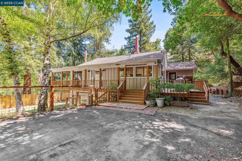 Tucked in the trees of Bollinger Canyon, this 2,303 sq ft home offers a rare blend of privacy and convenience on over half an acre of usable land. Enjoy peaceful, country-style living just minutes from top-rated schools, shopping, and downtown Moraga. Flexible floor plan with vaulted ceilings, two fireplaces, and a lower-level living space with private entrance—ideal for guest quarters, home office, or potential separate living. Lot may allow for an ADU (buyer to verify), offering multi-gen or income potential. A unique opportunity with room to grow.