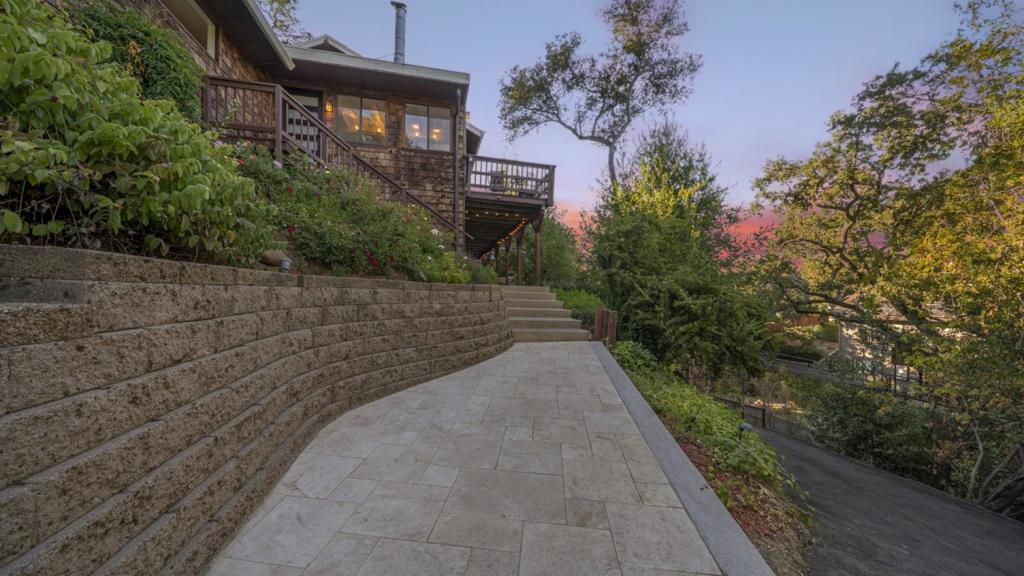Exceptionally large lot 5 minutes walk from Downtown. This beautifully remodeled home on a single-level offers a lifestyle of luxury, nature, and convenience, making it your chance to secure a foothold in this exclusive neighborhood. Additional 325 SF utility room. Stunning designer touches throughout. Exceptional views & privacy. Gorgeous open kitchen with island, breakfast bar, recessed lighting and high-end appliances. Stunning open living and dining areas with open beam ceiling, large windows, skylights and oversized sliding doors leading to huge deck. Gleaming floors. Central A/C. Dream primary suite with dual closets, private deck access and luxurious ensuite bathroom. All three bedrooms are spacious. Private backyard with beautiful tiered landscaping and enormous deck with multiple outdoor sitting, dining, work and entertaining spaces. Retreat-like tranquility and connection with surrounding nature. Walk to downtown Los Gatos, winery, dining, shopping and scenic hiking trails. Convenient commute location with easy freeway access. Award-winning schools: Louise Van David Lillo Meter Elementary, Raymond J. Fisher Middle and Los Gatos High.