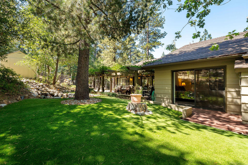 Welcome to Magical Meadow Glen Retreat, an extraordinary sanctuary set on two side-by-side lots, offering over a half-acre of peace, privacy, and natural beauty.Enjoy mostly single-level living, with gracious indoor and outdoor spaces designed for entertaining and unwinding. The covered rear patio draped in wisteria sets the stage for alfresco dining, while the soothing sounds of your private pond and cascading waterfall create a truly magical ambiance.A circular driveway leads to an attached 2-car garage, and an additional driveway between the two lots offers abundant parking for guests, RVs, or extra vehicles. The fenced rear yard is perfect for pets and playful afternoons.Inside, you will find large, flowing rooms with new luxury vinyl plank flooring, newer HVAC system, newer water heater, remote-controlled kitchen blinds, and a Generac generator with dedicated propane tank for peace of mind. The spacious Chef's kitchen opens to both formal and informal living areas, ideal for gatherings of any size.The bedrooms are bright and oversized, featuring ceiling fans, (2 w/walk-in closets), and direct outdoor access from two bedrooms. The Primary Suite is a showstopper with high ceilings, a wall of windows, and sliding doors leading to the backyard, a serene haven for birdwatching, quiet mornings, and reflection.With generous garage storage, mature landscaping, and a layout that blends function with natural elegance, this retreat offers nothing to do but move in and enjoy the lifestyle you've been dreaming of.
