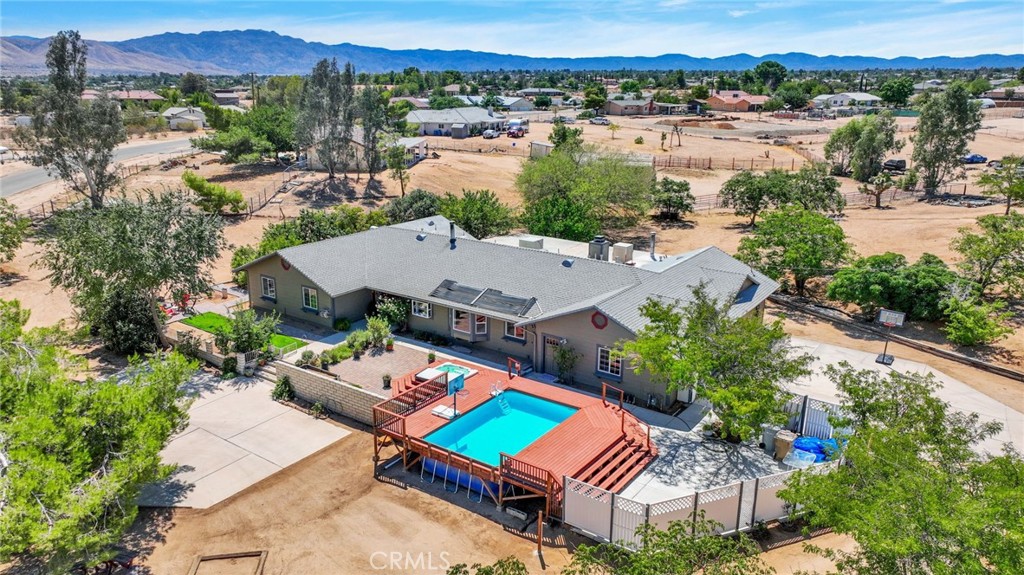 Opportunity Knocks. Sought After Hesperia Location. Large CORNER LOT . OVER 1-ACRE. 5-Gate access. Perfect set up for expansion or Ranchito. Zoned for Horses and Animals. Dog Run in place. RV Access. Horseshoes Anyone ? How about a dip in the POOL or JACUZZI. Decorative Fountain with Paver Area creates a great area to relax. 3500 SF PLUS Living Space . Looking for a home with MULTI GEN or MULTI FAMILY possibilities . This is it. Expansive great room can be used for endless possibilities . Game Room , Media, Room, Or add additional bedrooms. 2- wood burning Stoves . Den with Additional Fireplace. Open Kitchen with Breakfast nook area. Indoor Laundry. Upgraded Windows. 4-CAR GARAGE WITH WORKSHOP. And so much more. Create your own Oasis. A must see...