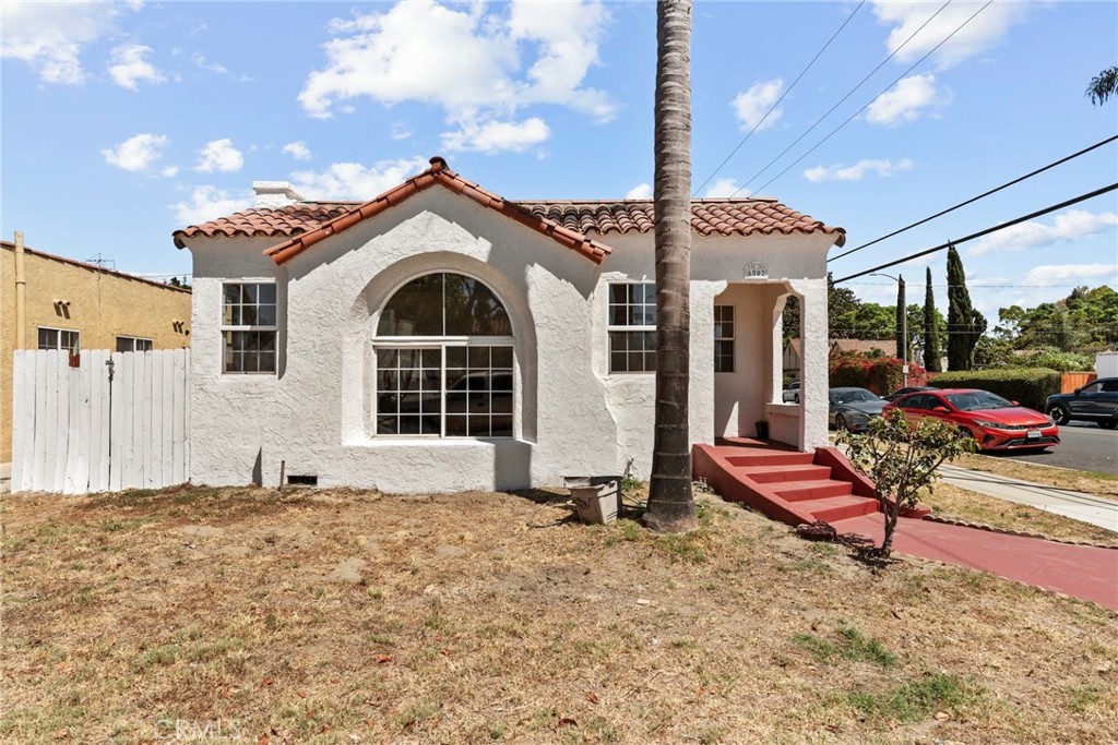Charming Spanish 1930s architecture, corner lot, detached garage with a fully enclosed rear yard. Enter through the heavy wooden front door to enjoy the freshly painted interior complete with recessed lighting, wood flooring and arched accents. The living, dining and kitchen spaces are open to one another - creating a great room experience. Enjoy the open kitchen's granite counters, stainless steel sink and appliances. The south facing windows of the kitchen, dining and living room let in so much natural light that the recessed lighting is really only needed at dusk! .Down the hall, on the north side are two spacious bedrooms with closets plus a walk in closet in the hallway - plenty of storage! Step out the back door to a covered walkway with a gardening area and entrance to the detached garage for easy and protected access to the laundry in the garage. Fully fenced yard. Around the back of the garage experience the fully landscaped oasis! Must see in person to appreciate! Spacious two car detached garage with extra storage space could be a candidate for an ADU in the future - imagine the possibilities! Central HVAC, freshly painted interior and exterior, corner lot - must see!