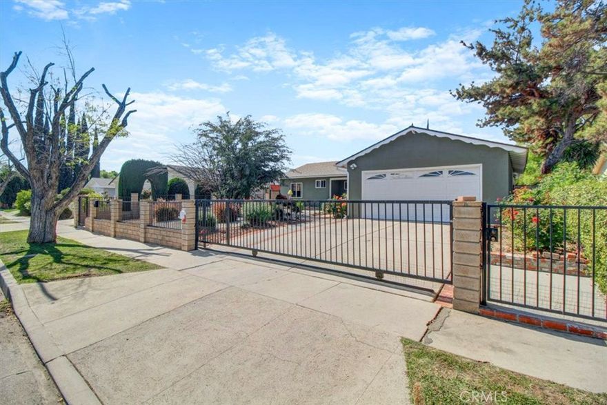 Northridge-adjacent, gated and remodeled 3-bedroom, 2-bathroom home with 1,305 sq ft of living space and a 2-car attached garage with direct access, located in a quiet residential neighborhood. Professionally landscaped, the home’s sharp curb appeal leads to a light-filled interior with an open floor plan, ideal for both everyday living and an indoor-outdoor lifestyle. This well-maintained residence has been updated with hardwood floors, double paned windows, recessed lighting, crown moldings and central air & heat. The formal entryway opens to a spacious living room with a fireplace and sliding doors, leading to a large covered patio, perfect for relaxing or entertaining with friends and family. The dining area can fit a large table comfortably. The remodeled kitchen features granite countertops and backsplash, ample cabinetry and storage, newer appliances, tiled floors, and direct access to the 2-car garage. Spacious primary bedroom with an ensuite bath featuring a remodeled dual-sink vanity and a large, tiled shower with a rain showerhead. Two additional well-sized bedrooms and a fully remodeled hallway bathroom with a bathtub complete this updated home. Oversized 2-car garage with automatic roll-up door, laundry area, and a driveway providing additional gated parking on the property. Close to freeways, parks and supermarkets, this is a great house on a tree-lined street in an excellent neighborhood. Shown by appointment. Available immediately.