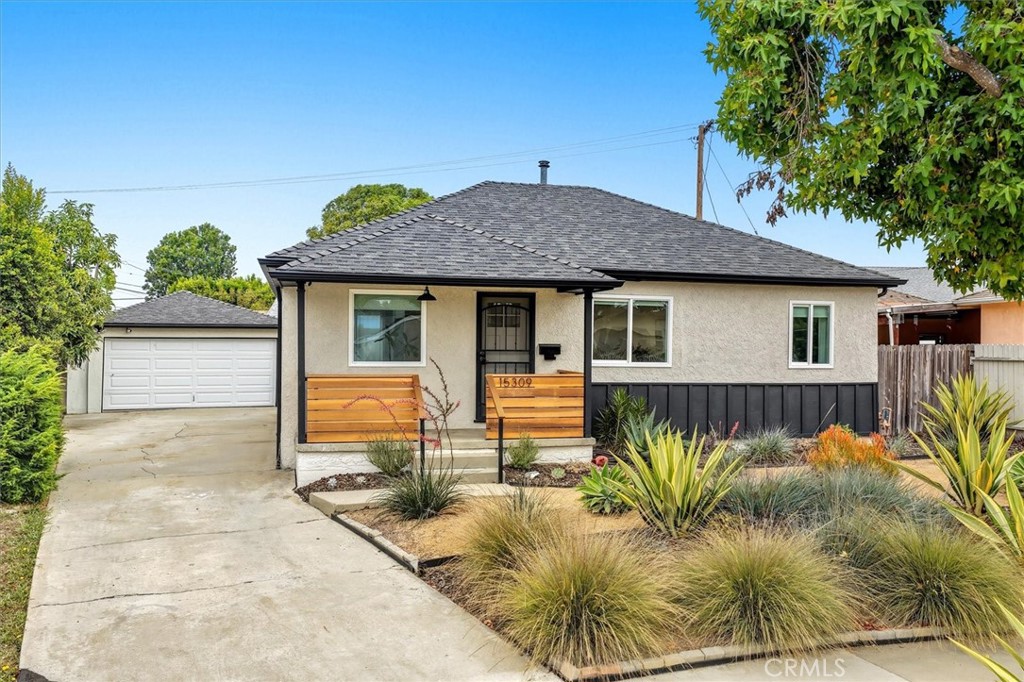 On a quiet, tree-lined street in El Camino Village, this home blends timeless charm with extensive renovations. The location is tucked off the main road with less traffic, beautiful mature trees —perfect for morning and evening walks. Inside, the home feels open, light, and warm, with a down-to-studs kitchen and bath renovation featuring quartz counters, stainless steel appliances, new cabinetry, tile, dishwasher, sink, and under-sink RO filtration system, plus updated piping and modern finishes in the bath. New dual-paned windows and doors, laminate floors, refinished hardwoods, recessed lighting, a custom porch fence, and drought-tolerant landscaping with fruit trees all add to the appeal. Major upgrades include a new water heater, updated 200A electrical panel, PEX piping, and a new HVAC system with heat pump. The backyard offers a covered patio, and privacy, with a detached garage, new slab and door, and a long driveway with RV potential. All this just minutes from Alondra Park, El Camino College, shopping, dining, freeways, and ~5 miles to the beach. Zoned for California Distinguished Mark Twain Elementary.