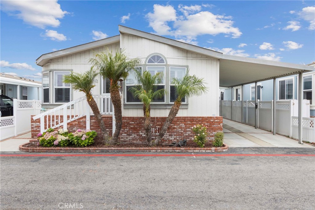 This 3-bedroom, 2-bathroom manufactured home offers 1,560 square feet of living space in one of Huntington Beach’s most established coastal communities. Just minutes from the beach, downtown, and Pacific City, Huntington Shorecliffs provides convenient access to the best of Surf City along with a full suite of resident amenities. The home features an open living and dining area, with a semi-enclosed kitchen that includes a bright bay window, skylight, and dedicated eating space. Off the living room is a versatile bedroom with double glass doors—ideal for a guest room, office, or den. The second guest bedroom is located down the hall and accommodates a full or queen-sized bed, with the guest bathroom positioned directly across. At the end of the hallway, the primary suite includes a large walk-in closet, ample natural light, and a full en-suite bathroom. The primary bath features dual vanities, a soaking tub, separate walk-in shower, and built-in storage. Additional highlights include a private paved patio, covered carport, and low-maintenance outdoor space. Community amenities include two pools, two spas, two clubhouses, fitness center, game room, barbecue area, and more. A well-located home in a sought-after neighborhood just minutes from the coast.