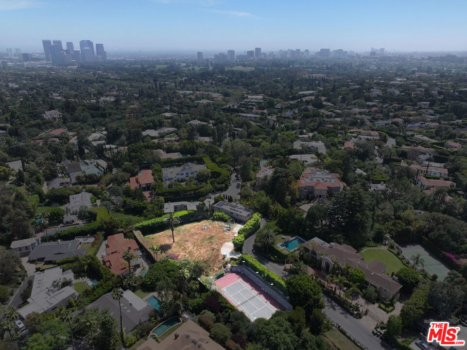 Extremely rare development opportunity in Prime Beverly Hills. Set on nearly a full acre of buildable land in a coveted pocket of Beverly Hills, this North/South-facing tennis court estate presents a limited chance to create a world-class residence. All plans and permits have been pulled, approved by the city and paid for! Construction can begin tomorrow on this 13,975 square-foot architectural masterpiece by the acclaimed Hafco Group, renowned for designing some of the city's most notable homes, this property is an extraordinary canvas for luxury living. Privately positioned and surrounded by prestigious estates, the site boasts exceptional privacy, views, and an expansive footprint rarely available in this A+ location. Opportunities of this caliber, offering a blend of size, location, and design pedigree are extremely hard to come by.
