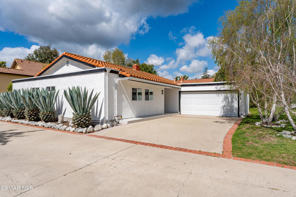 Welcome to 1161 Triunfo Canyon Rd, a masterfully reimagined retreat where modern elegance meets relaxed California living. Spanning over 1,700 sq. ft., this stunning 3-bedroom, 3-bath home seamlessly blends sleek contemporary design with warm, natural elements.Experience the charm of the inviting living room, where light natural wood-beamed ceilings and a smooth stucco fireplace create an airy yet cozy ambiance. Large sliding doors open to the backyard patio, perfect for effortless indoor-outdoor living. The stylish kitchen is a true showpiece, featuring striking black wood-grained cabinetry, pristine quartz countertops, stainless steel finishes, and a unique island with bar seating--ideal for entertaining.The primary suite is a private sanctuary with soaring ceilings, a walk-in closet, and direct access to the backyard. The spa-like primary bath boasts an oversized shower, exquisite custom tile work, and a natural wood vanity. Two well-sized secondary bedrooms enjoy a beautifully designed bath, complete with sleek black herringbone tile floors and a shower/tub combination.Designed for year-round entertaining, the backyard offers low-maintenance landscaping, an oversized built-in BBQ with ample seating, and a remote-controlled patio cover to enjoy in any weather.Perfectly located just a short distance from Westlake Lake and the best of Westlake Village, this home also offers access to top-rated schools. A rare blend of luxury, style, and convenience--this is California living at its finest.