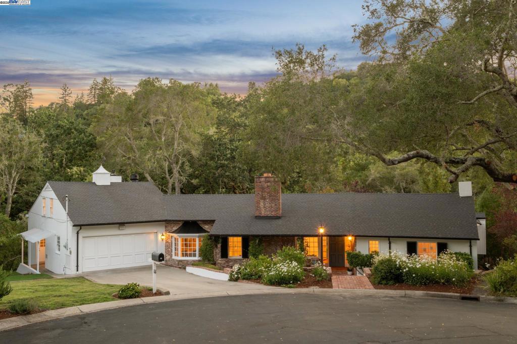 Elegance and natural beauty abound in this updated Traditional 4BD/4.5BA plus Studio/1BA apt., offering estate living on over an acre in Orinda’s Sleepy Hollow. Set on a quiet cul-de-sac, this classic 3820 SQFT home features an ensuite bath in every bedroom and several French doors opening onto an expansive covered veranda bringing the beautiful outdoors inside. One wing of the home features a sunny living room with fireplace and built-in shelves, a dining room with picture bay window and built-in cabinets, and a fully renovated chef’s kitchen with a large adjacent den – all rooms with doors opening wide for wonderful indoor/outdoor living. Down a hallway, find a powder room, big laundry room with sink, storage, and interior access to the two-car garage. The sleeping wing boasts four roomy bedroom suites, including the primary with French doors outside and stairs to a lower level with a sauna and flexible space ready as an office. Above the garage, the studio apartment has a large galley kitchen and separate entrance. The grounds are exceptional with level grassy lawns and gardens, surrounded by a beautiful California oak woodland. Down the road, enjoy top-rated public schools, Sleepy Hollow Swim & Tennis Club, Orinda Country Club, Briones Hills trails, Orinda Village, and BART.
