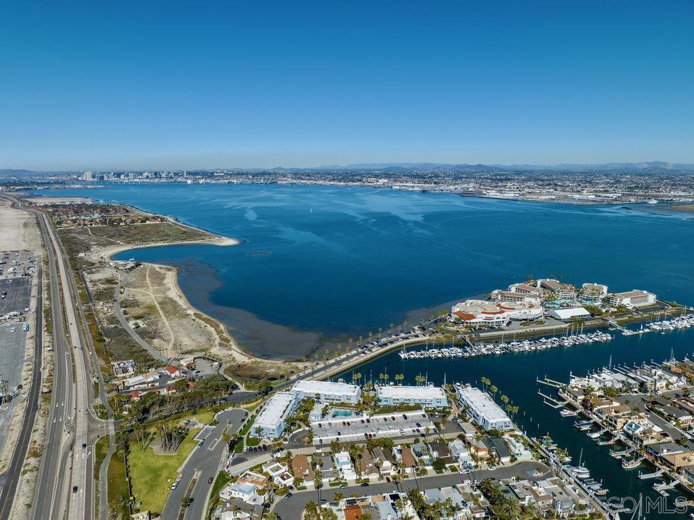 PRICE REDUCTION! Incredible value to purchase the best location in Montego Bay Club. This Condo has spectacular views of the Bay and Downtown San Diego from the living room and open kitchen. This is a chance of a lifetime with this entry level priced unit to get your foot in the door of the prestigious Coronado Cays Community. Enjoy the coastal breezes in the summertime with access to the beach and bay just steps away. 2 En-suite bedrooms with bathrooms are located upstairs away from the living area. 1/2 bath downstairs for convenience just off of large living room. Pool, Spa and Clubhouse with Billiards/Ping Pong table in this gated complex. Loew's Resort just steps away with pools, wellness spa, restaurants and Marina where all of your favorite water toys can be rented. Pickleball/tennis/basketball courts and dog park are just a stroll away. Pet Friendly Community with abundant greenbelt areas, trails for daily walks and bike paths for E-Bike enthusiasts. Every day is like being on vacation. HOA is in process of building a carport for 2 parking spaces. Option for buyer to pay for the carport to be enclosed with a garage door.