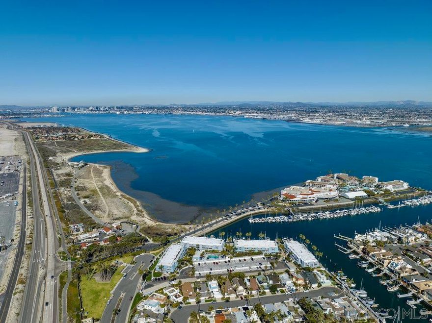 PRICE REDUCTION! Incredible value to purchase the best location in Montego Bay Club. This Condo has spectacular views of the Bay and Downtown San Diego from the living room and open kitchen. This is a chance of a lifetime with this entry level priced unit to get your foot in the door of the prestigious Coronado Cays Community. Enjoy the coastal breezes in the summertime with access to the beach and bay just steps away. 2 En-suite bedrooms with bathrooms are located upstairs away from the living area. 1/2 bath downstairs for convenience just off of large living room. Pool, Spa and Clubhouse with Billiards/Ping Pong table in this gated complex. Loew's Resort just steps away with pools, wellness spa, restaurants and Marina where all of your favorite water toys can be rented. Pickleball/tennis/basketball courts and dog park are just a stroll away. Pet   Friendly Community with abundant greenbelt areas, trails for daily walks and bike paths for E-Bike enthusiasts. Every day is like being on vacation. HOA is in process of building a carport for 2 parking spaces. Option for buyer to pay for the carport to be enclosed with a garage door.