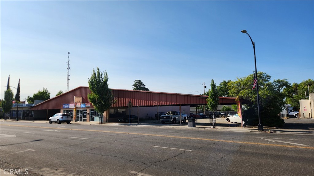 PRIME COMMERCIAL WITH EXCELLENT VISIBILITY AND STRONG TRAFFIC COUNTS. Located in the heart of Downtown Corning, on the main corridor, and only 3/4 of a mile +/- from Interstate 5. The Subject Property consists of an approx. 6500 sq. ft. retail glass storefront building, with a large fenced parking lot on one side of the building, and covered carport parking on the opposite side of the building , an ample size retail/showroom, 2-3 private offices, bathroom, and a workshop/warehouse with 2 roll up doors, and alley access at the rear of the building. The Subject Property is ideal for automotive sales, repair, or tires, but would also work for a multitude of other retail/commercial uses.