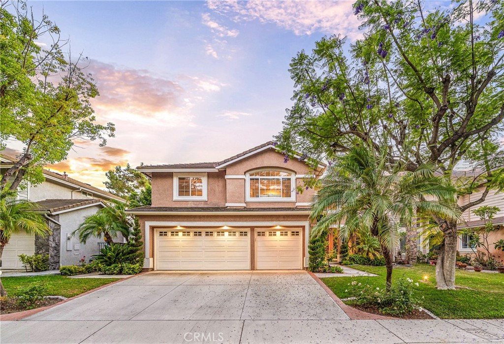 Light, bright and airy residence situated at the heart of great neighborhood cul-de-sac in the prestigious highly sought after guard-gated community of Canyon Crest. Beginning with great curb appeal, that includes mature planter beds and statement piece shade tree, the tone is set before one even steps inside. Upon entry, rich, warm and inviting wood floors, and neutral tones, host an exceptional abundance of natural light. With soaring vaulted ceilings, the living and dining room spaces are ample in size and showcase an elegant setting for hosting. Just off of the formal living areas is a downstairs bedroom and, along with the three quarter lower level guest bath, this could be an ideal one-story living option. A separate laundry room with a dedicated task sink adds convenience. The spacious family room, just off the kitchen, is the perfect space to gather around the fireplace, making entertaining effortless. The kitchen is a chef’s dream, with beautiful quartz countertops, a central island with an inset gas cooktop, tons of great prep and storage space, top-of-the-line appliances, custom cabinetry, and updated fixtures, lighting and hardware throughout. A convenient eat-in area and great light make the kitchen and family room the places where all the action is sure to happen. Upstairs, the grand primary suite offers a tranquil retreat, complete with great light, vaulted ceilings and an ensuite with a large dual sink vanity, step-in shower, soaking tub and a private water closet. The two upper guest bedrooms share a full bathroom with Jack-and-Jill sinks. The backyard is perfect for enjoying evening sunsets and has a large grassy lawn and multiple seating areas making this a fantastic spot to entertain under the stars. A large three-car garage offers ample storage space for vehicles and more and a large 3 car driveway completes the residence. Homeowners in this exclusive community enjoy low HOA fees, which includes access to the clubhouse, three pools, a spa, a full gym, sauna, sports courts, tennis courts, a multipurpose room, park, 24-hour roaming security guards, and multiple gates. Conveniently located near award-winning Blue Ribbon schools, Lake Mission Viejo, shops, restaurants and the best of what South OC living has to offer. This home presents sophistication and practicality in what is definitely a must see opportunity. WELCOME HOME!