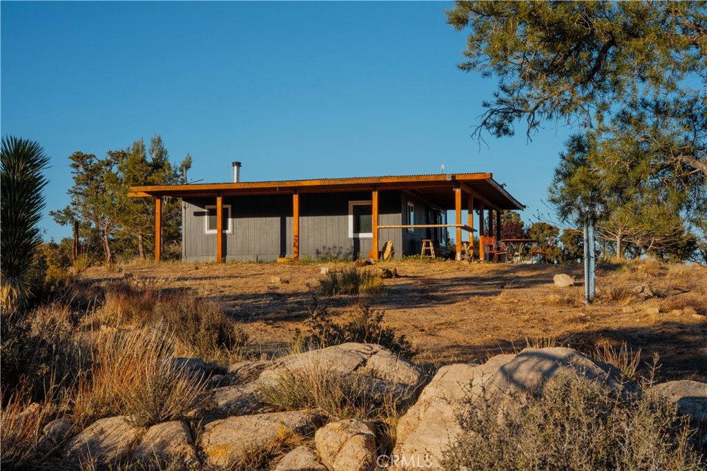 Adventure Awaits at Relaxita Ranch!
Welcome to your ultimate off-grid playground — 5 breathtaking acres where the open desert stretches to the east, pine-covered mountain valleys rise to the west, and opportunity expands in every direction. At Relaxita Ranch, every sunrise floods the high desert with light, and every sunset paints the mountains in deep, glowing color.
This is the off-grid paradise you’ve been dreaming of, fully equipped with a high-producing private well and lightning-fast Starlink internet to stay connected on your own terms. The massive solar array capable of running the compound for up to multiple days without sun is comprised of an Outback Inverter and Charge controller 48V system, with a whopping 7 5.3kwh lithium ion batteries.
The heart of the property is a charming 2-bed, 1-bath main house, a brand-new 16’x20’x4.5’ pool, a giant 1,200-square-foot Quonset hut perfect for work, play, or visionary projects, an expansive outdoor gaming area, and a custom-built forno a legna outdoor kitchen for unforgettable gatherings under the stars.
Whether you crave peaceful remote work during the week or want to host epic weekend retreats with friends, Relaxita Ranch has the space, the infrastructure, and the spirit to make it happen.
And there’s more: plans and permits are already in place for a brand-new 1-bed, 1-bath ADU — you can break ground tomorrow and build this dream compound out even more.
Secluded yet accessible, you’re just 25 minutes to Mane Street in Pioneertown and the legendary Pappy & Harriet’s, 30 minutes to downtown Yucca Valley, and 20 miles to Big Bear’s alpine adventures. Your backyard has no limits with BLM and national forest neighboring your property lines all over.
At Relaxita Ranch, there are no limits — just wide-open skies and infinite possibilities.