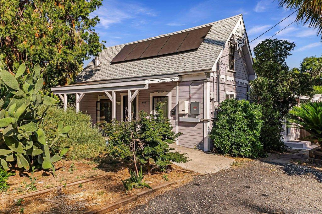 This charming home is move-in ready, featuring all-new blinds and a spacious master bedroom adorned with two large chateau windows. Accessibility is a key feature, with an easy entry that has no steps, and the bathroom is equipped with a 36-inch door, grab bars, and a double shower head for added convenience. There is a generous 16x30 attic bonus room provides ample space for various uses. The tranquil backyard boasts lemon and mandarin trees, along with grapevines, enhancing the outdoor experience. Additionally, the property includes an easily transferable one-year-old leased solar power system complemented by a whole house battery that nearly eliminates your PG&E bill. The home also features a one-year-old roof, a fully fenced yard, a gas floor furnace, and window air conditioning, with ceiling fans throughout for comfort. The front yard showcases drought-resistant native landscaping. This property features an existing 351 sqft Accessory Dwelling Unit equipped with a gas wall furnace, two window air conditioners, and private enclosed yard space, all illuminated by LED lighting. This property is a split-able lot and a great opportunity to add an additional ADU. Owner may carry.