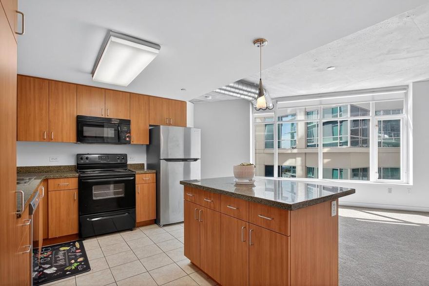 This spacious 2-bedroom, 2-bath condo offers 913 sq ft of contemporary urban living in the heart of East Village. The unit features floor-to-ceiling windows, high concrete ceilings, a private balcony, granite countertops in the kitchen, and a full-size stackable washer/dryer. Residents enjoy Smart Corner amenities including a rooftop hot tub, BBQ and WiFi-enabled lounge area, fully equipped fitness center, and on-site security. Includes 1 assigned underground parking space.