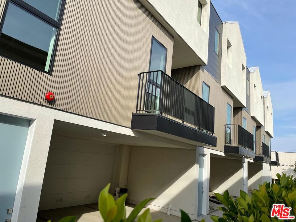 Welcome to this newly built 3-story modern townhome featuring 4 bedrooms and 3 full bathrooms. The second floor boasts an open-concept layout ideal for entertaining, complete with a spacious kitchen, large center island, dining area, and living room with 10-foot ceilings and access to a private balcony. One bedroom is conveniently located on the main level perfect for a home office, gym, or guest room. The third floor offers three bedrooms, including a generous primary suite with 15-foot vaulted ceilings, an en-suite bath, and ample closet space. Additional features include a two-car garage with storage space, central HVAC, Nest thermostat, in-unit washer and dryer, and all kitchen appliances included. Secure gated entry provides added peace of mind. Centrally located with easy access to Culver City, Beverly Hills, West Hollywood, the Westside, Downtown LA, and the 10 freeway.