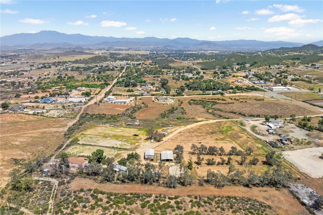ROOM FOR EVERYONE!! MULTI-FAMILY OPPORTUNITY, OR GREAT INVESTMENT! Located in the rapidly growing City of Menifee! Don’t miss this rare chance to own two manufactured homes on 8.73 usable acres in one of Southern California’s fastest-developing cities! Perfectly located just minutes from the 215 Freeway, shopping, dining, and city amenities. Both homes are on permanent foundation featuring 2 bedrooms, 2 bathrooms, en suite primary bedrooms/ bathrooms, separate propane tanks, and are on well and septic. One is 1,344 square feet and the other is 810 square feet. Reliable long-term tenants are already in place and would love to stay—making this an immediate income property from day one. The land is fully usable and ideal for equestrian enthusiasts, featuring an 8-stall mare motel with Francisco pipe fencing, and the property was formerly used for dressage and hunter/jumper training. There is plenty of space to add additional infrastructure, and with a prime location, this property offers limitless potential—live, lease, expand, or develop! Don't let this one slip by; schedule your private tour today!