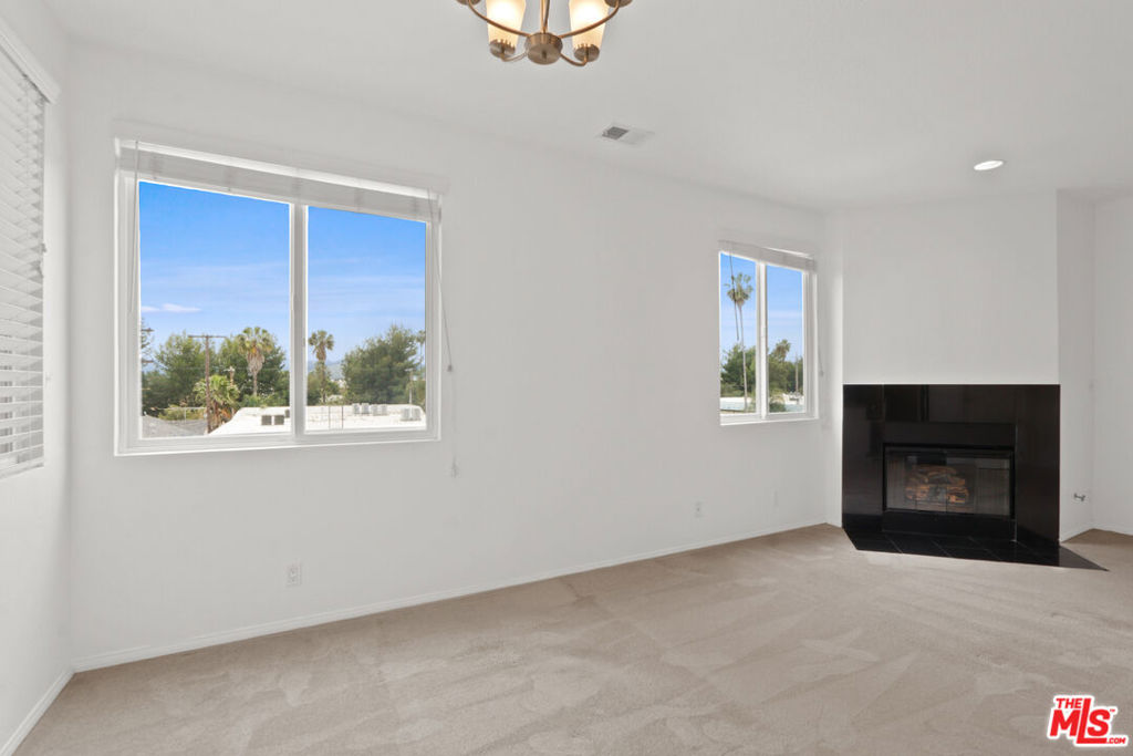 Discover the charm of Valley Village penthouse living in this fantastic 2-bedroom, 2-bathroom, 1160 sq ft top floor condo. As a corner unit it boasts stunning east and southern views, high ceilings, and plentiful natural light throughout. With freshly repainted walls, this home exudes warmth and appeal. The thoughtfully designed floor plan features a spacious living and dining area with beautiful windows, a fireplace, and easy access to a kitchen equipped with stainless steel appliances, stone countertops, and abundant cabinetry and storage. The primary suite offers ample closet space and a large en suite bathroom with an oversized vanity and a tiled bathtub and shower. The second bedroom offers southern mountain, city views, treetops. This property ensures easy access parking with its two-car tandem space in a gated garage. With secured access and the added convenience of an in unit laundry area, this condo epitomizes modern living. Located on a peaceful street near the NOHO arts district and Toluca Lake West, you'll be close to the area's best shops and restaurants.