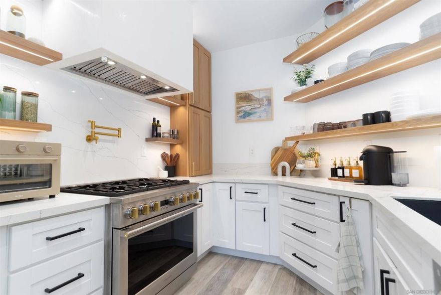 Immaculate Bonita Creek home!  Highly upgraded living space with custom kitchen featuring white oak, white shaker cabinets, and solid white oak floating shelves, full stone backsplash with dramatic island waterfall, built-in brass water spout, stone farmhouse sink, stainless steel built-in-refrigerator, 36" 6 burner GE Monogram range, premium light fixtures throughout, custom wood trim in living room with gallery lighting, custom Venetian plaster fireplace surround with remote start lighter, luxury vinyl plank flooring, new Sherwin-Williams paint throughout, remodeled bathrooms boast designer tile-in showers and tubs,  newer water heater and AC. Attached garage with electric vehicle charger. Private house with no backyard or side neighbor and yard with green space views, gated community with pool/spa!