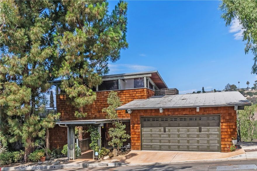 Discover a rare architectural masterpiece, offered for the first time in history and exquisitely designed by renowned architect Chris Abel. Nestled into the serene landscape of Bluebird Canyon, this home epitomizes the quintessential Laguna Beach lifestyle with its seamless blend of sophisticated design and breathtaking natural surroundings. Stepping inside this 2,318 square-foot split-level home, you are immediately drawn into its captivating post-and-beam design. The welcoming eat-in kitchen sets a convivial tone, guiding you toward the heart of a residence where floor-to-ceiling windows marry the inside with the outdoors framing magnificent canyon and ocean views. This design truly invokes a coastal treehouse vibe. Find sanctuary in 3 private bedrooms, each opening to its own balcony. The primary suite is the crown jewel, offering ultimate seclusion on a sun-drenched private deck. The lowest level is dedicated to leisure and wellness, a versatile family room or flex space provides ample room for relaxation and recreation. And a private sauna creates a spa-like experience, perfect for unwinding after a day at the beach. Outside, the property blends gracefully into the hillside. A built-in bar anchors the backyard, inviting endless opportunities for outdoor gatherings against a backdrop of stunning views. A dedicated workshop offers an ideal space for a home office, storage or expansion. This is a unique chance to claim a piece of Abel architectural history as your home. Don’t miss the moment to embark on a new chapter where opportunity and serenity await.