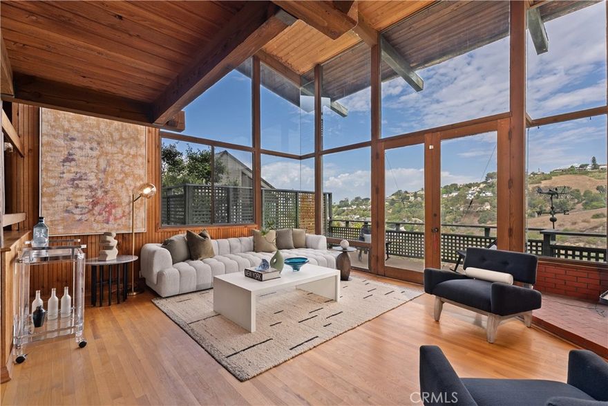 Discover a rare architectural masterpiece, offered for the first time in history and exquisitely designed by renowned architect Chris Abel. Nestled into the serene landscape of Bluebird Canyon, this home epitomizes the quintessential Laguna Beach lifestyle with its seamless blend of sophisticated design and breathtaking natural surroundings. Stepping inside this 2,318 square-foot split-level home, you are immediately drawn into its captivating post-and-beam design. The welcoming eat-in kitchen sets a convivial tone, guiding you toward the heart of a residence where floor-to-ceiling windows marry the inside with the outdoors framing magnificent canyon and ocean views. This design truly invokes a coastal treehouse vibe. Find sanctuary in 3 private bedrooms, each opening to its own balcony. The primary suite is the crown jewel, offering ultimate seclusion on a sun-drenched private deck. The lowest level is dedicated to leisure and wellness, a versatile family room or flex space provides ample room for relaxation and recreation. And a private sauna creates a spa-like experience, perfect for unwinding after a day at the beach. Outside, the property blends gracefully into the hillside. A built-in bar anchors the backyard, inviting endless opportunities for outdoor gatherings against a backdrop of stunning views. A dedicated workshop offers an ideal space for a home office, storage or expansion. This is a unique chance to claim a piece of Abel architectural history as your home. Don’t miss the moment to embark on a new chapter where opportunity and serenity await.