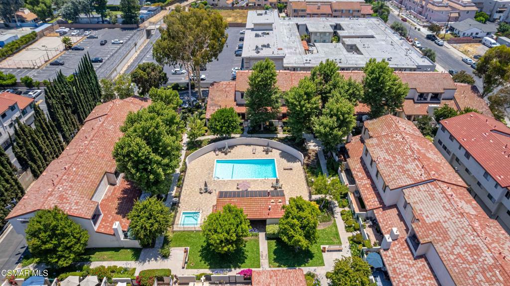 WOW! 20K price improvement, best value in complex with a recent model match sale in July at 775k! Great value, fix and save! Poolside Sanctuary with Incredible Potential in the Heart of Tarzana! Welcome to 18220 Oxnard St. #105 in the highly desirable Encino Village Townhomes -- a rare opportunity to own a spacious, airy townhome in a highly desirable Tarzana community. Perfectly positioned in an interior, poolside location, this serene retreat offers a unique blend of comfort, privacy, and upside potential. Step inside to discover vaulted ceilings and an open, spacious layout that flows seamlessly from the cozy fireplace in the living room to a charming breakfast nook, formal dining and more. Light and bright primary suite with vaulted ceilings and full bath and a private balcony overlooking the sparkling pool and lush trees. Whether you're enjoying your morning coffee or winding down after a long day, this peaceful view creates a true sense of retreat. With great bones and endless potential, this home invites you to make it your own -- bring your vision, fix and save, and customize a space that reflects your lifestyle. Enjoy the comfort of a massive, attached garage, perfect for storage, hobbies, or a workshop. Community amenities include a sparkling pool, spa, Gym/Ex Room, clubhouse, and racquetball court -- all steps from your door. Located close to the Metro line, Warner Center, shopping, dining, and more, this home combines accessibility with tranquil living. A rare find with highly desirable upside potential -- don't miss this chance to create your ideal sanctuary in one of Tarzana's most sought-after complexes!