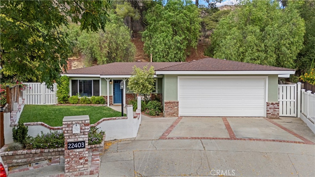 No HOA, No Mello Roos! Tucked at the end of a quiet cul-de-sac in the heart of Santa Clarita, this beautifully updated single-story home offers the perfect blend of timeless charm, smart-home convenience, and high-quality craftsmanship.
Step inside to find brand new flooring and abundant natural light that fills the spacious, open-concept living areas. Designed for modern living, the home features Alexa-enabled smart technology, giving you voice-controlled comfort and efficiency in every room.
At the heart of the home is a truly special craftsman-style kitchen, thoughtfully designed with handmade cabinetry, quartz countertops, a farmhouse sink, walk-in pantry, and a stunning parota wood island that anchors the space—both functional and a one-of-a-kind showpiece.
The living and dining areas are perfect for entertaining, with a classic brick fireplace and seamless indoor-outdoor flow. The primary suite is a private retreat with vaulted wood-beam ceilings, direct access to the screened patio, and a spa-like bath with dual vanities, a soaking tub, glass-enclosed shower, and skylight.
Two additional bedrooms offer versatility for guests, family, or office use, served by beautifully updated bathrooms and INDOOR LAUNDRY for added convenience.
Out back, enjoy multiple outdoor spaces including a custom-built deck, screened patio, and terraced garden beds—all surrounded by mature landscaping and a serene hillside with no rear neighbors.
22403 Los Rouges Drive offers privacy, quality, and modern comfort—an exceptional opportunity in one of Santa Clarita’s most desirable neighborhoods.